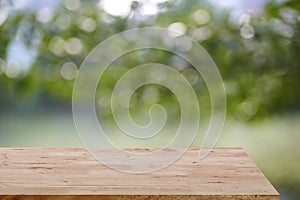 Wooden board empty table blur trees background