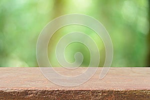 Wooden board empty table blur trees in forest background - can be used for display or montage your products.