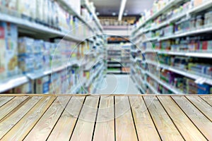 Wooden board with empty table blurred shopping mall background.