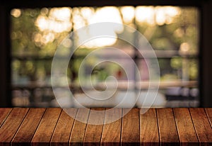 Wooden board empty table cafe, coffee shop, bar blurred backgro