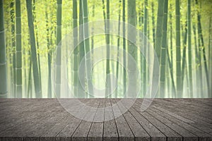 Wooden board empty table in front of bamboo forest background.