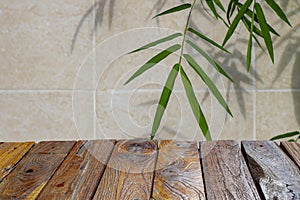 Wooden board empty table in front of bamboo green leaves background for display of product