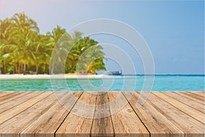 Wooden board empty table in front of blue sea & sky background.