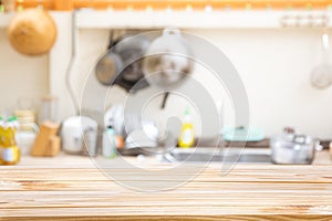 Wooden board empty table in front of Blur image of traditional Kitchen Room