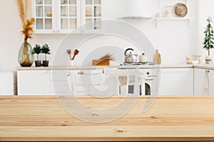 Wooden board empty table in front of a blurred background. Perspective brown wood with a blurred background of the kitchen and