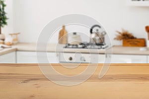 Wooden board empty table in front of a blurred background. Perspective brown wood with a blurred background of the kitchen and
