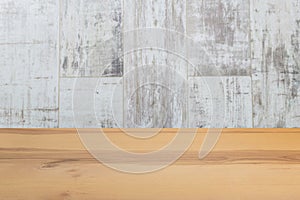 Wooden board empty table in front of a blurred background. Perspective brown wood with blurry grunge or old wall backdrop - can be