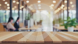 Wooden board empty table in front of blurred background. Perspective brown wood over blur in coffee shop - can be used for display