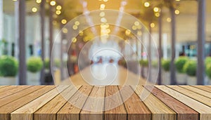 Wooden board empty table in front of blurred background. Perspective brown wood over blur in coffee shop - can be used for display