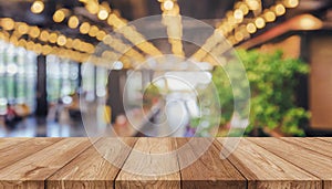 Wooden board empty table in front of blurred background. Perspective brown wood over blur in coffee shop - can be used for display