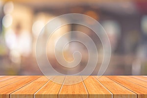 Wooden board empty table in front of blurred background. Perspective brown wood over blur in restaurant - can be used for display