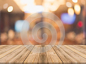 Wooden board empty table in front of blurred background. Perspective brown wood over blur in restaurant - can be used for display