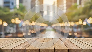 Wooden board on empty table in front of blurred background, perspective brown wood table over blur forest for mockup or product