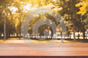 Wooden board empty table in front of blurred background. Perspective brown wood table over blur trees in forest background