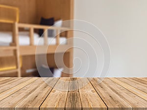 Wooden board empty table in front of blurred hotel building background. Perspective brown wood over blur bedroom.