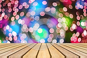 Wooden board empty table in front of colorful blurred background. Perspective brown wood over bokeh light