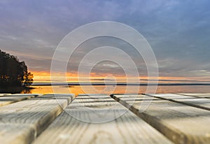 Wooden board empty table in front of sunset sea