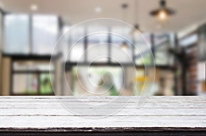 Wooden board empty Table Top And Blur Interior over blur in coffee shop Background, Mock up for display of product