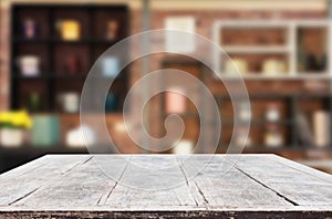 Wooden board empty Table Top And Blur Interior over blur in coffee shop Background, Mock up for display of product