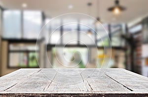 Wooden board empty Table Top And Blur Interior over blur in coffee shop Background, Mock up for display of product