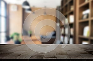 Wooden board empty Table Top And Blur Interior over blur in coffee shop Background, Mock up for display of product