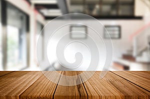 Wooden board empty Table Top And Blur Interior over blur in coffee shop Background, Mock up for display of product