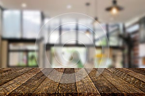 Wooden board empty Table Top And Blur Interior over blur in coffee shop Background, Mock up for display of product