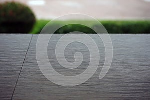 Wooden board empty table top on of blurred background.