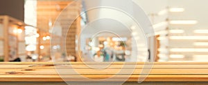 Wooden board empty table top blurred background. Perspective brown wood table over blur in coffee shop background.Panoramic banner