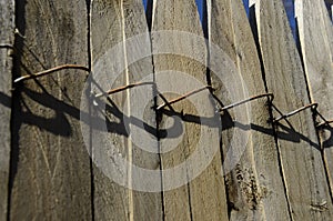 WOODEN BOARD FENCE CONNECTED BY WIRE