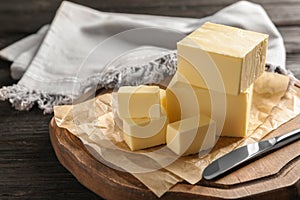 Wooden board with fresh butter and knife