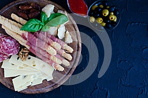 Wooden board full of mediterranean appetizers