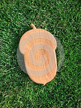 Wooden board on green grass background