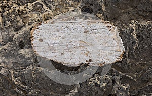 wooden board nailed to stones background