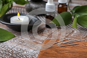 Wooden board with needles for acupuncture on table