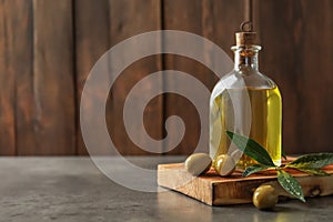 Wooden board with olives and fresh oil