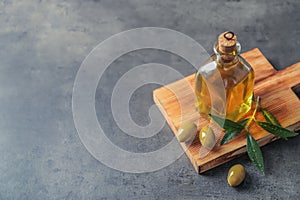 Wooden board with olives and fresh oil