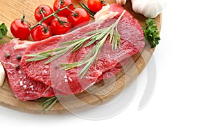 Wooden board with raw meat, vegetables and spices on white background