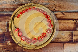 Wooden board with red pepper cut into slices hot sauce with copy space