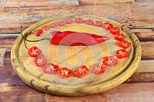 Wooden board with red pepper cut into slices hot sauce with copy space