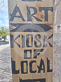 Wooden board sign for a kiosk and art center