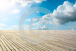 Wooden board square and blue sky with white clouds