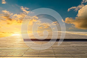 Wooden board square and sunset yellow sky