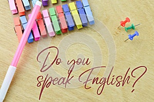 Wooden board written with DO YOU SPEAK ENGLISH