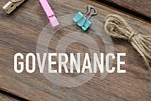 Wooden board written with GOVERNANCE. Business concept