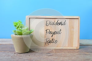 Wooden board written with text DIVIDEND PAYOUT RATIO