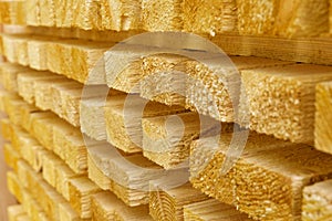 Wooden boards, bars close-up in a lumber warehouse.