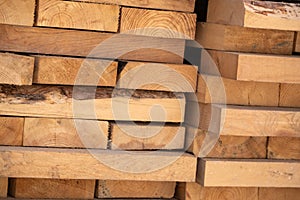 Wooden boards of different sizes are stacked in a pile. Background.