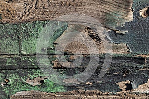 Wooden boards with a pronounced texture and traces of old green paint, old green paint on wooden boards, traces of time