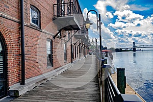 Wooden boardwalk along the Cape Fear River overlooking the Memorial Bridge Wilmington, NC